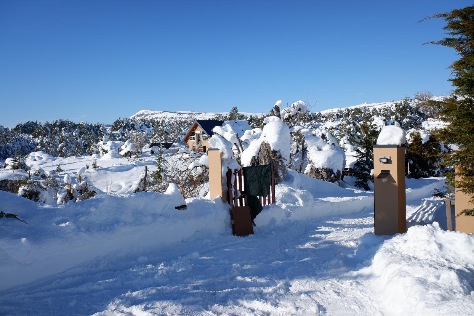Friday January 8th 2021, Plateau de Caussols, South of France, A snowy open entrance gate to a house